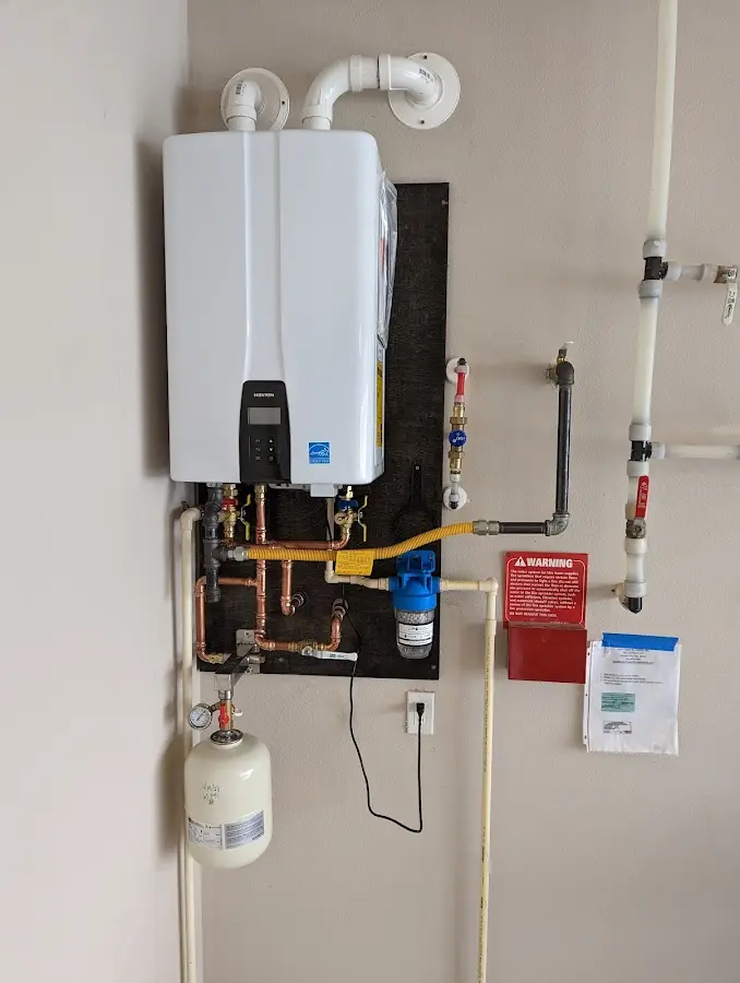 Professional plumber installing copper piping in a Highland Park home